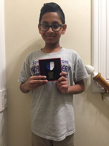 kid holding award